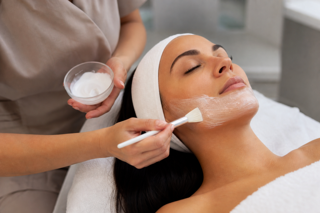 Esthetician applying cooling hydrating mask to client's face