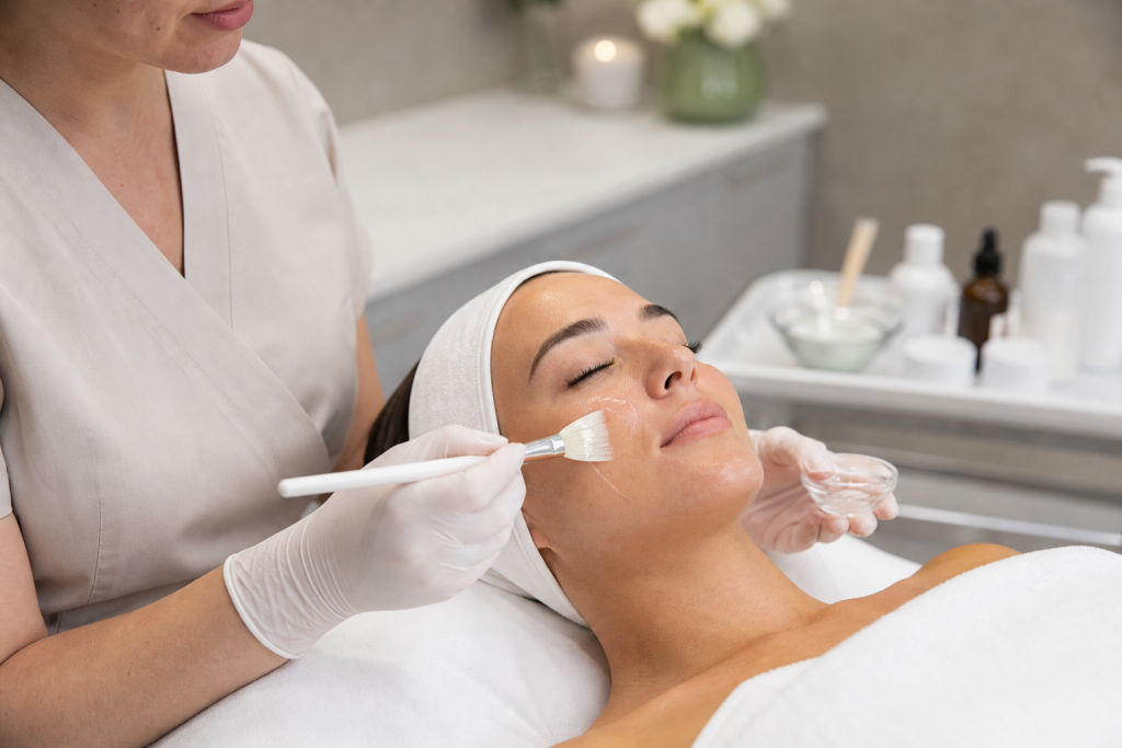 Therapist applying serum during a professional facial treatment.